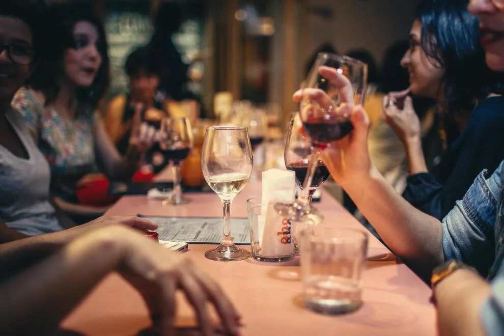 Photos d'un groupe de personnes
qui dînent au restaurant, pour illustrer l'article "Comment rencontrer quelqu'un sans passer par internet ? Mes conseils"