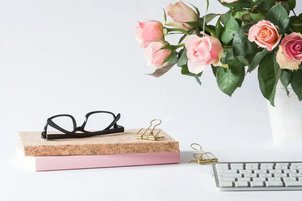 Clavier d'ordinateur, carnet de notes et bouquet de roses.